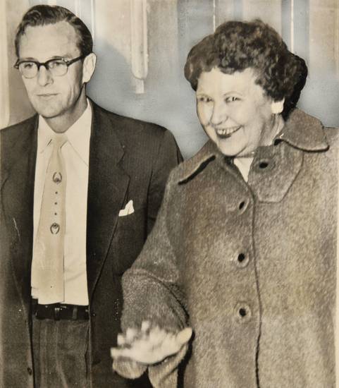 Nannie Doss, 49, walks into the county attorney's office with investigator Ross Billingsley on Nov. 27, 1954. 